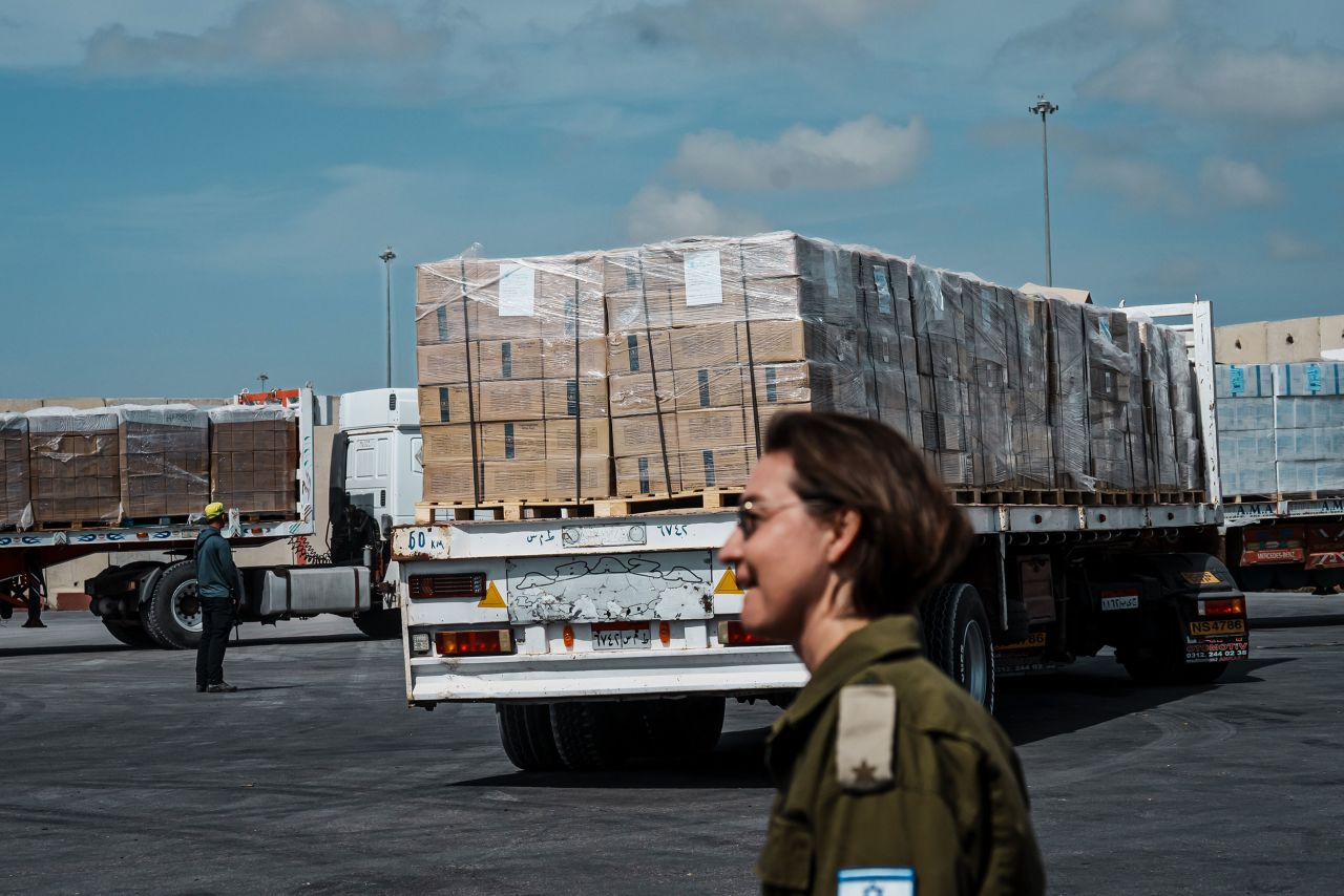 Trucks carrying humanitarian aid move through security inspections at the Kerem Shalom crossing in March.