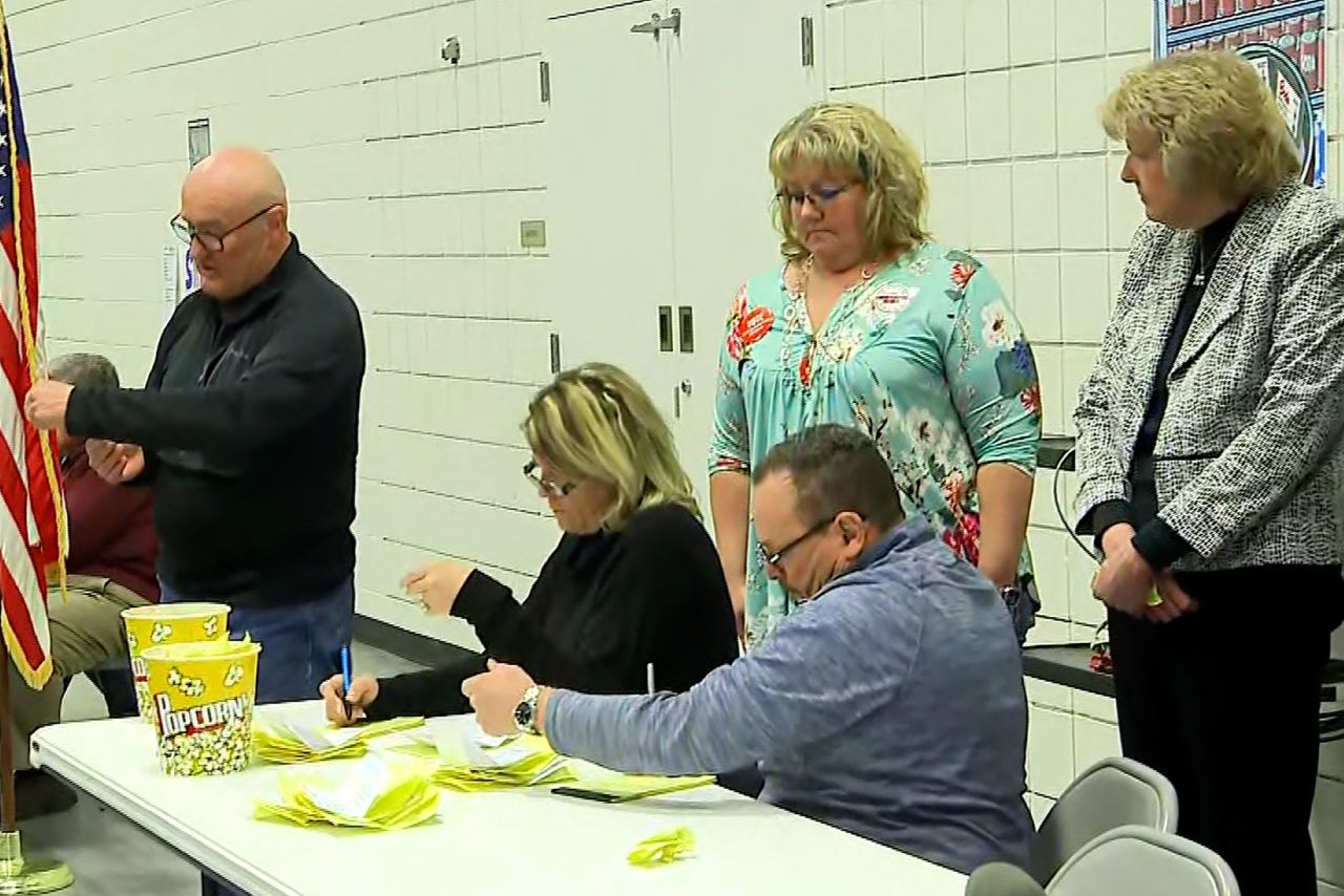 Caucus workers pull votes from a popcorn bucket in Iowa on Monday.