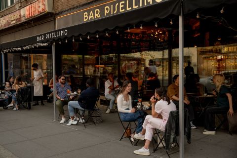 People dine outside in New York on April 28.
