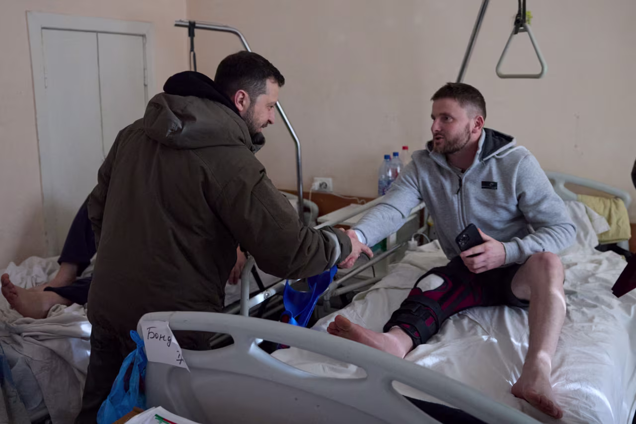 Ukraine's President Volodymyr Zelensky shakes hands with an injured service member as he visits a hospital on the Day of the Ukrainian Armed Forces, in Kharkiv, Ukraine, on December 6.