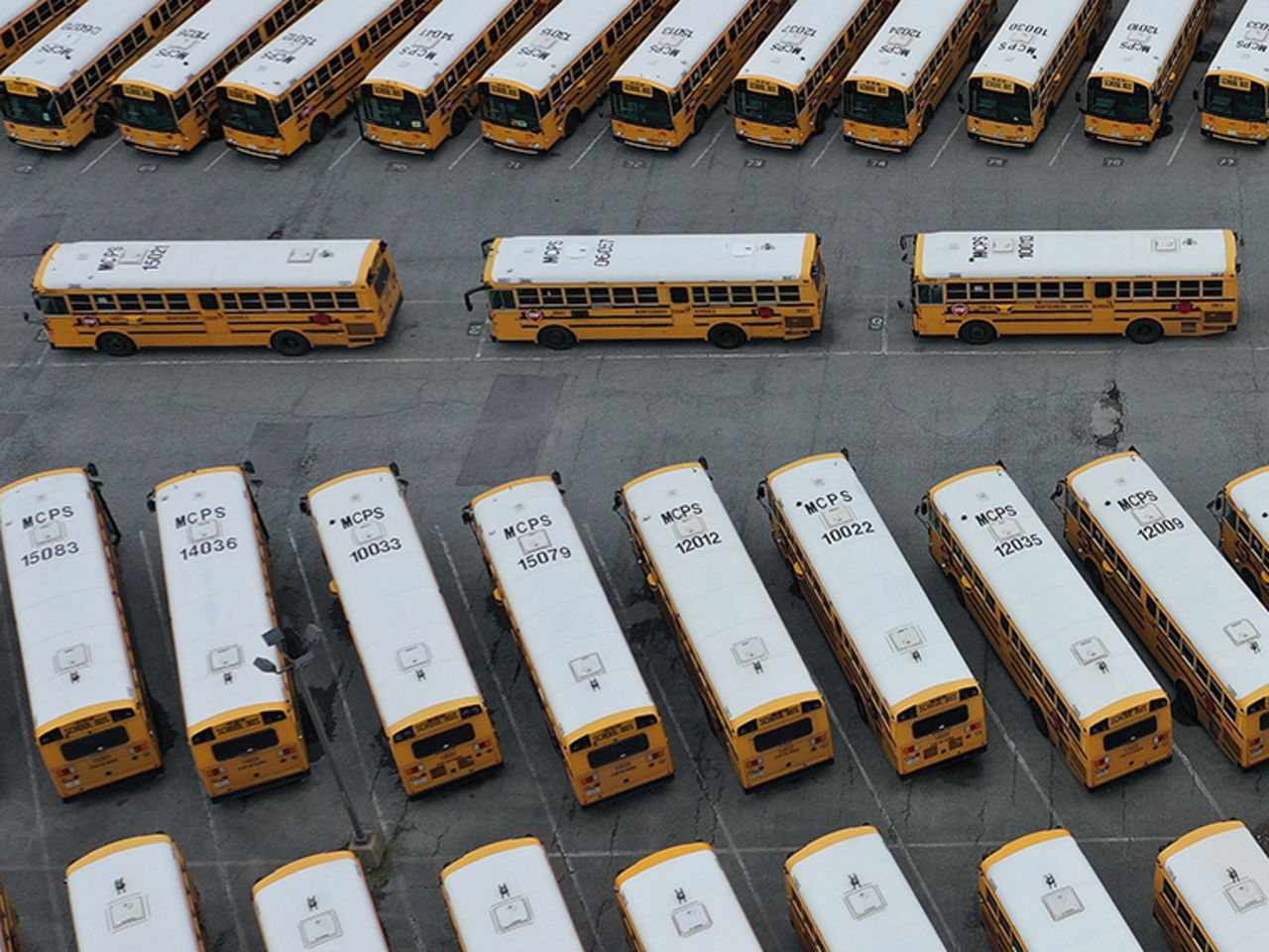 About 200 school buses are parked at the Montgomery County Schools Clarksburg Bus Depot, idled by the closing of schools across Maryland in response to the novel coronavirus outbreak, on March 16, in Clarksburg, Maryland.