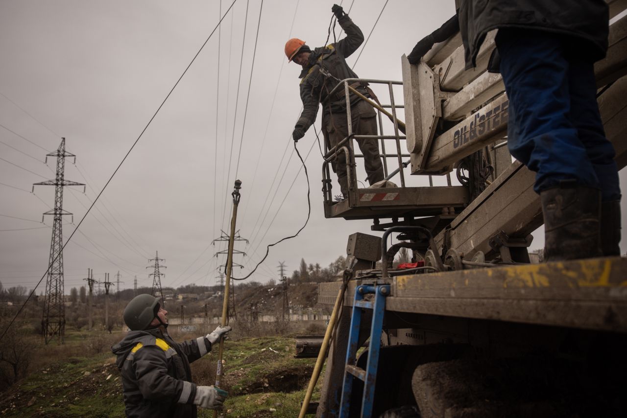 Electricity workers fix a destroyed high voltage power line on Thursday in Kherson, Ukraine.