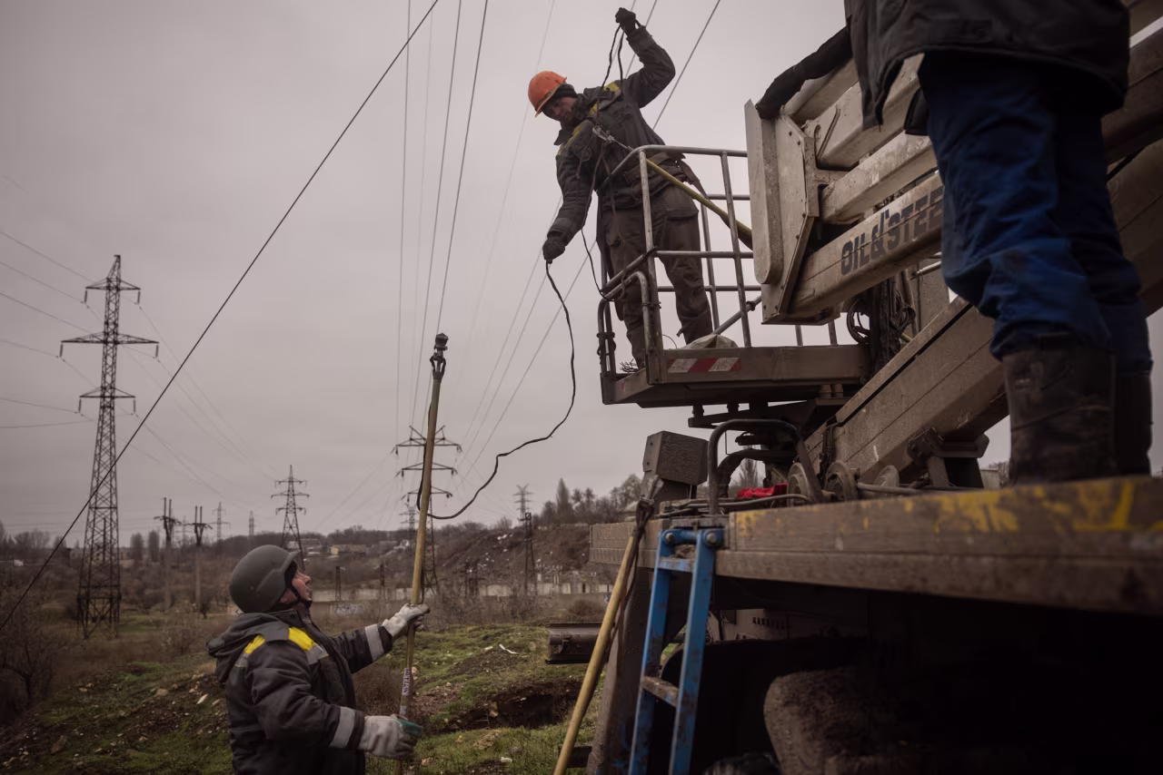 Electricity workers fix a destroyed high voltage power line on Thursday in Kherson, Ukraine.