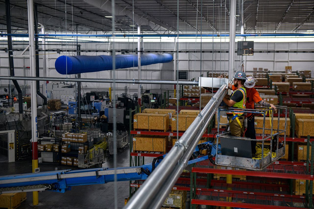 Workers at the Linamar Corp. of Canada EV battery case manufacturing facility in Muscle Shoals, Alabama, in October 2023.