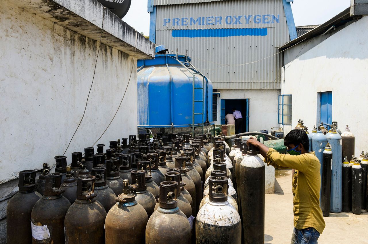 A worker arranges medical oxygen cylinders to transport to hospitals for the Covid-19 coronavirus treatment in a facility on the outskirts of Hyderabad on April 23.