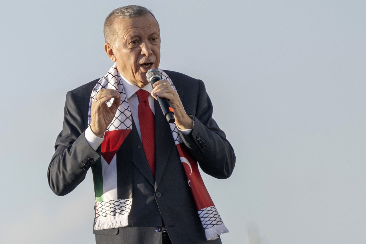 Turkish President Recep Tayyip Erdogan wears a scarf with both Turkish and Palestinian flags as he addresses a rally organized by the AKP party in solidarity with the Palestinians in Gaza, in Istanbul, Turkey on October 28. 