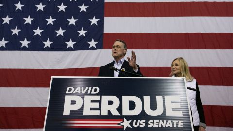 Sen. David Perdue and his wife, Bonnie, address the crowd during a campaign rally at Peachtree Dekalb Airport on December 14, in Atlanta.