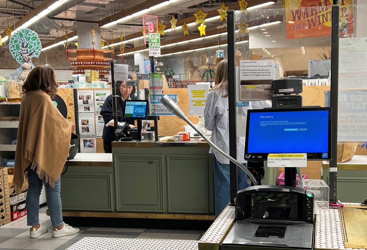A cash register shows a blue screen at a grocery store affected by a cyber outage in Sydney, Australia on July 19.