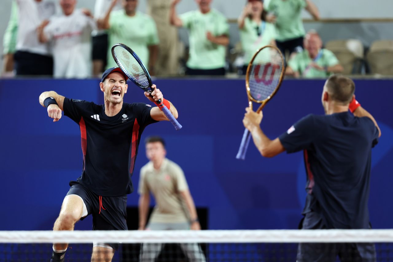 Andy Murray of Great Britain celebrates with partner Dan Evans after winning against Belgium, in Paris, on July 30.