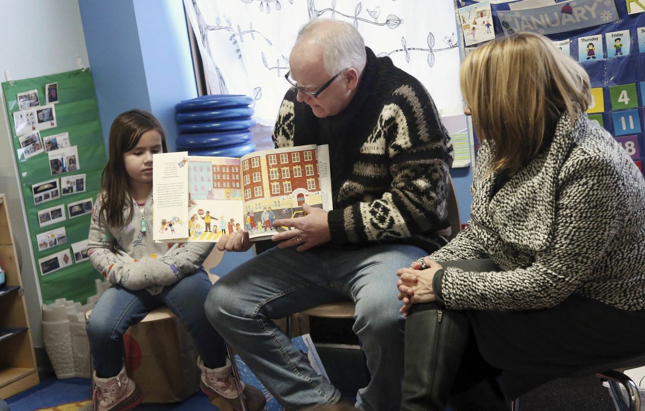 Walz reads a book to children in January 2019 at People Helping People, a shelter in Minneapolis for families experiencing homelessness amid extreme cold weather conditions.