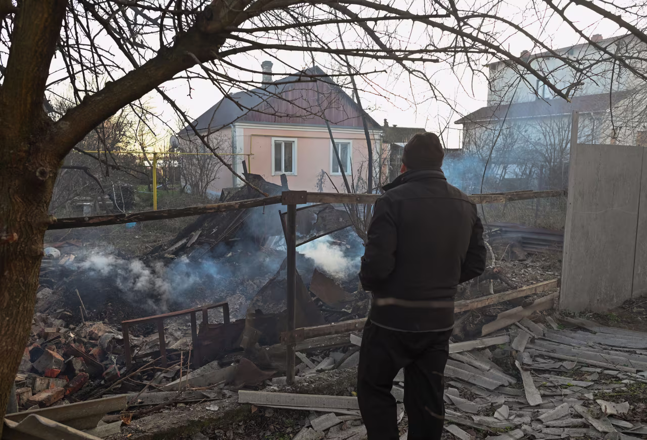 A man looks at a destroyed house near Kherson shipyards after a missile attack on Karabell Island in Kherson, Ukraine, on December 14.