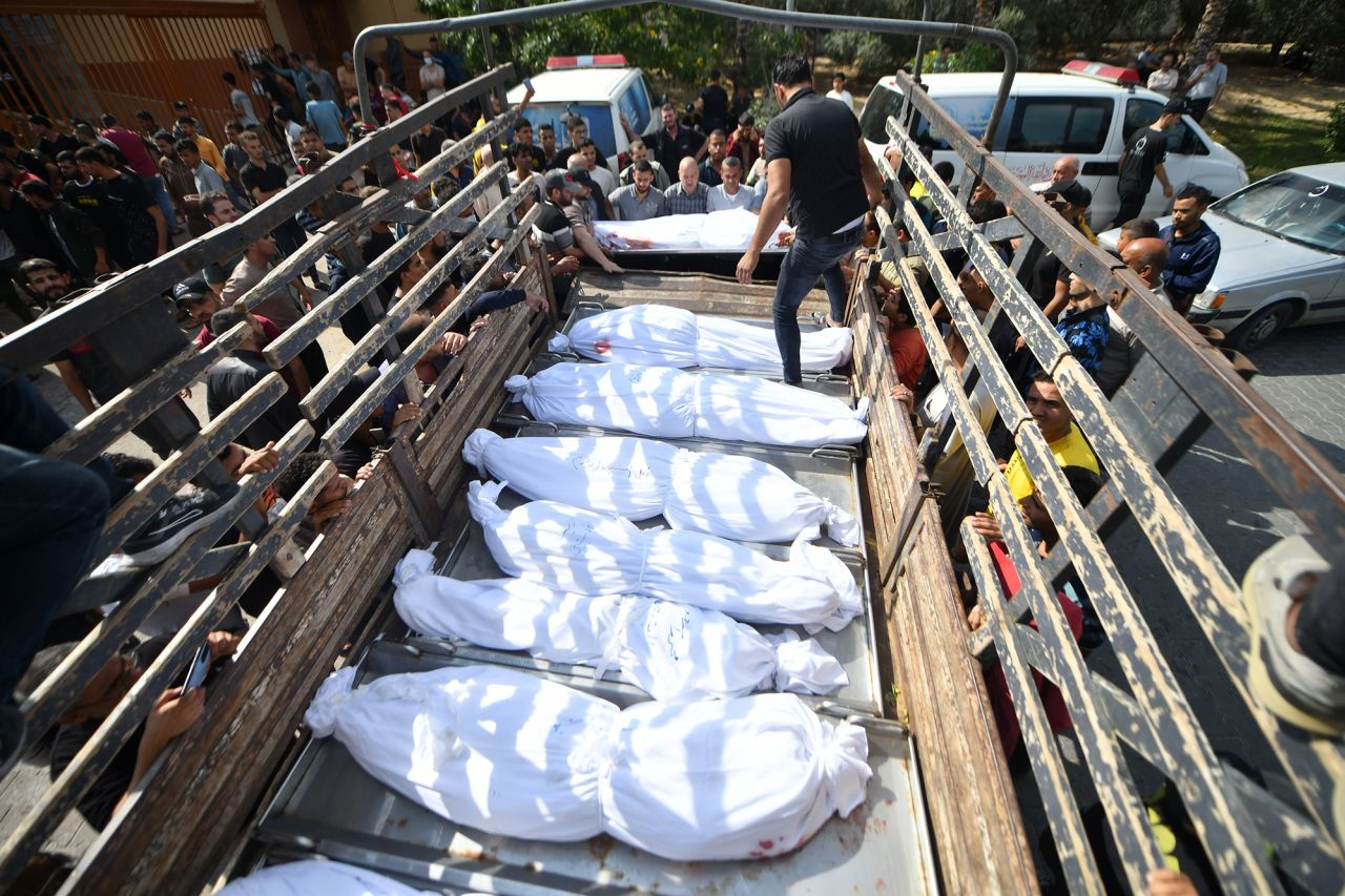 Bodies of Palestinians killed in Israeli airstrikes wait outside at the Nasser Hospital to be buried after a funeral prayer in Khan Yunis, Gaza, on October 12.