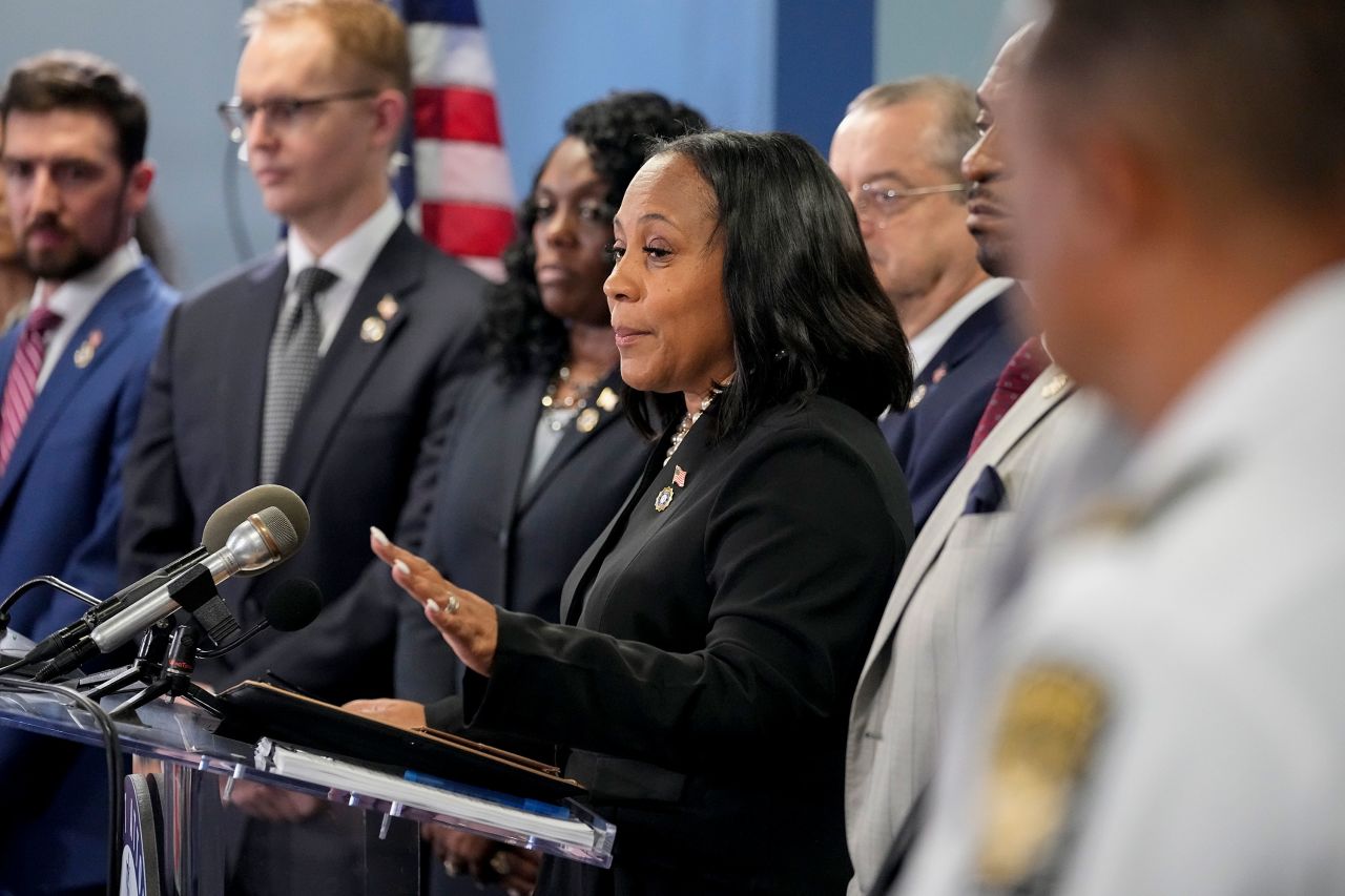 Fulton County District Attorney Fani Willis, center, speaks in the Fulton County Government Center in Atlanta during a press conference on Monday.