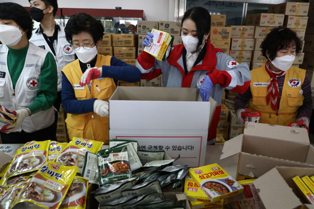 South Korean Red Cross workers prepare emergency relief kits packed with basic necessities for delivery to impoverished people experiencing difficulties amid the spread of coronavirus on March 27, in Seoul, South Korea. 