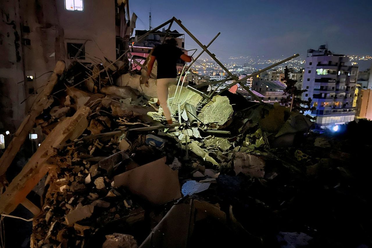 A man inspects a damaged building that was hit by an Israeli airstrike in the southern suburbs of Beirut on Tuesday.