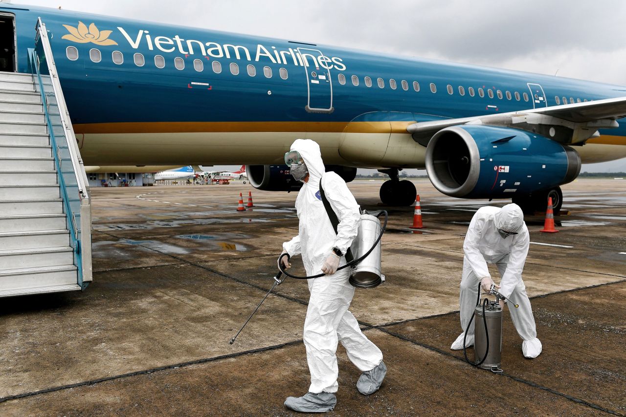 Workers prepare to disinfect a Vietnam Airlines plane at Noi Bai International Airport in Hanoi, Vietnam on March 3.