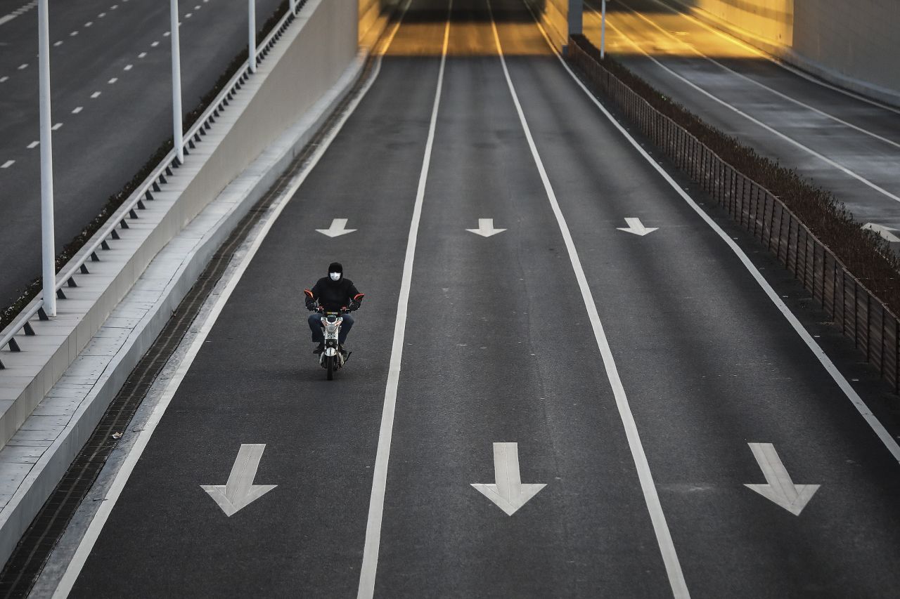 A man cycles on an empty street at Optical Valley in Wuhan, Hubei province, China. 