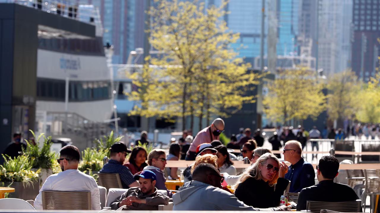 People enjoy their time in an outside sitting area of a restaurant in Chicago's Navy Pier on Friday, May 14. 