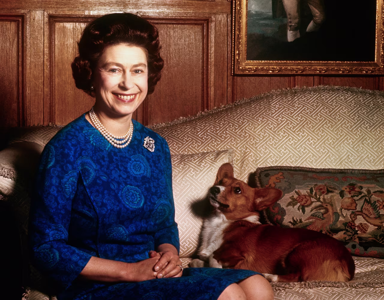 Queen Elizabeth poses for a picture with one of her Corgi's at Sandringham House, Norfolk on February 4, 1970.