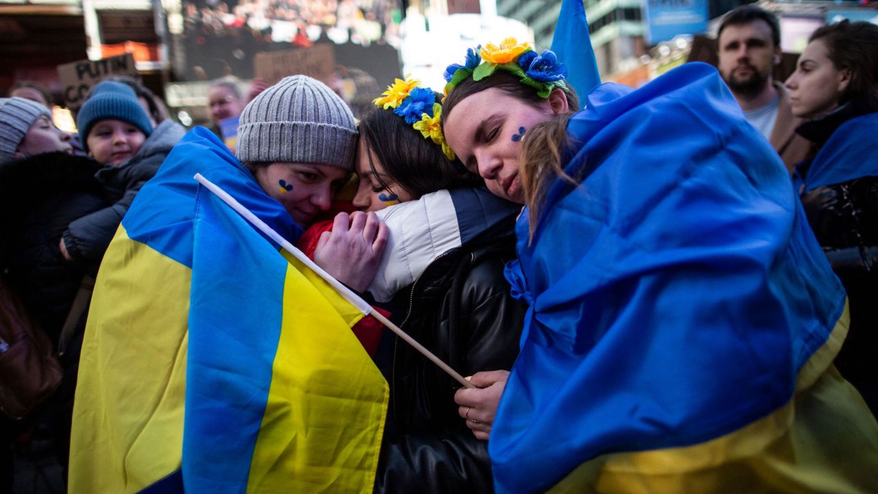 People in New York's Times Square embrace during a rally in support of Ukraine on Saturday.