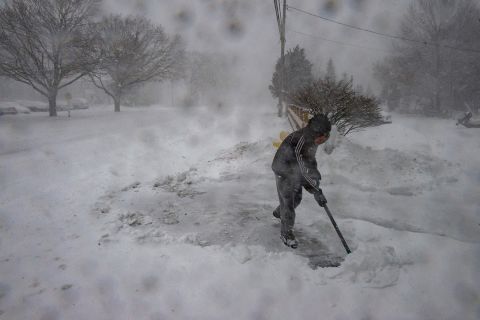 A man shovels snow in near whiteout conditions during a nor'easter in Marshfield, Massachusetts, on January 29.