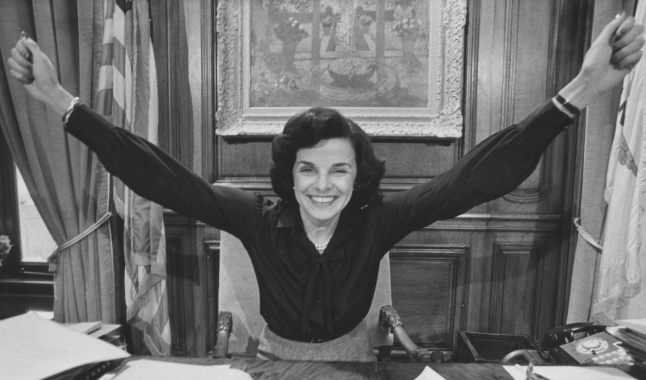 Dianne Feinstein, her arms outstretched in celebration, in her office in San Francisco City Hall after she was elected mayor.