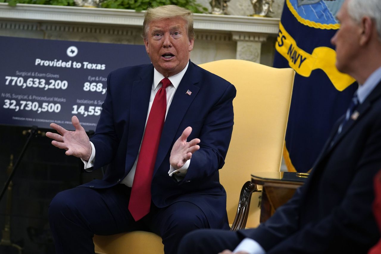 President Donald Trump speaks as Vice President Mike Pence listens at right during a meeting about the coronavirus response in the Oval Office of the White House in Washington on May 7. 