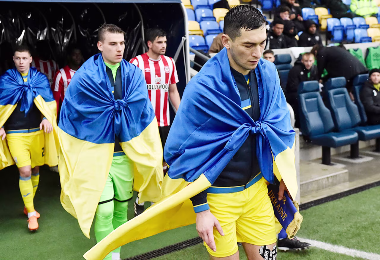 Midfielder Taras Stepanenko leads Ukraine out against Brentford B on March 23. 