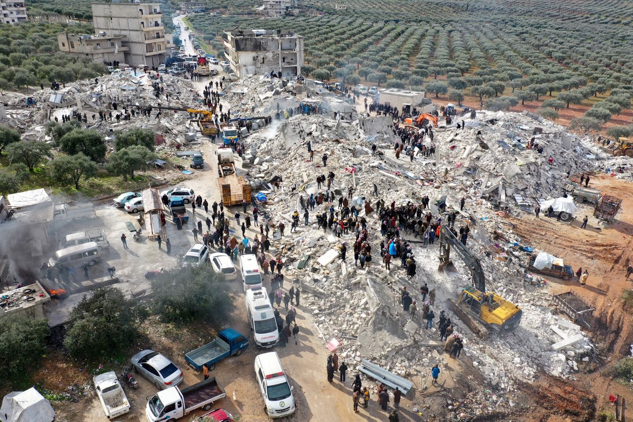 Residents, aided by heavy equipment, searching for victims and survivors amidst the rubble of collapsed buildings following an earthquake in the village of Besnia, on February 6.