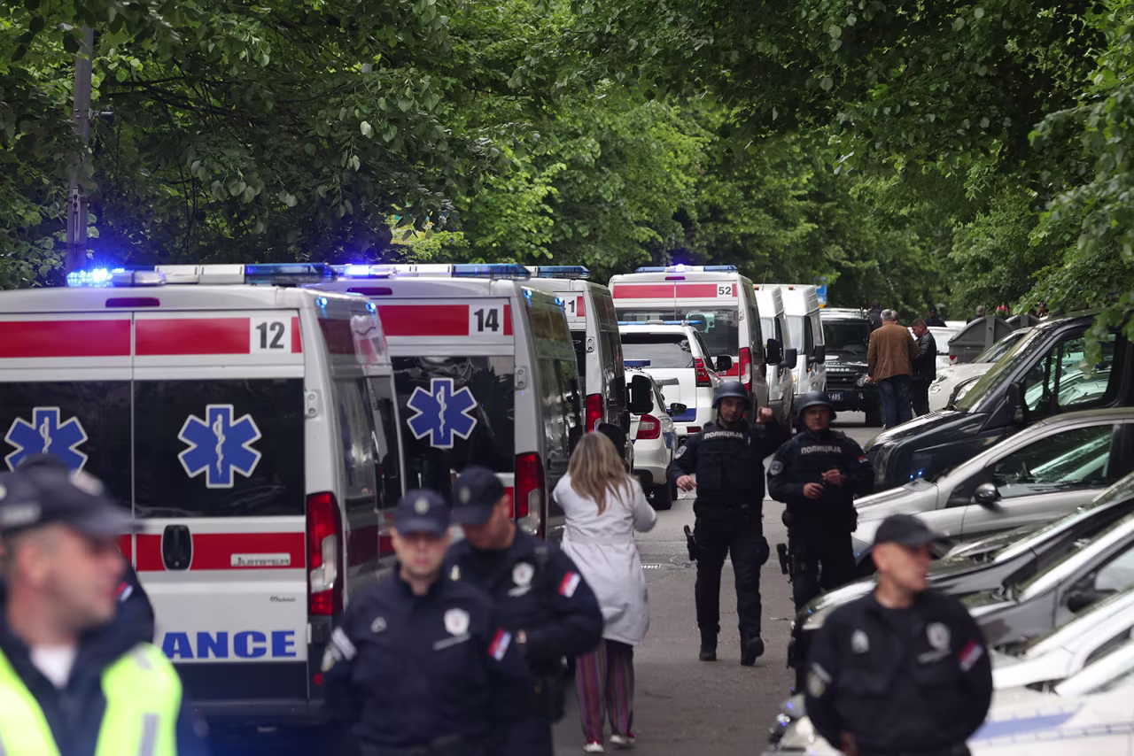 Ambulance cars stand ready as police officers block a street near the Vladislav Ribnikar elementary school on Wednesday in Belgrade. 