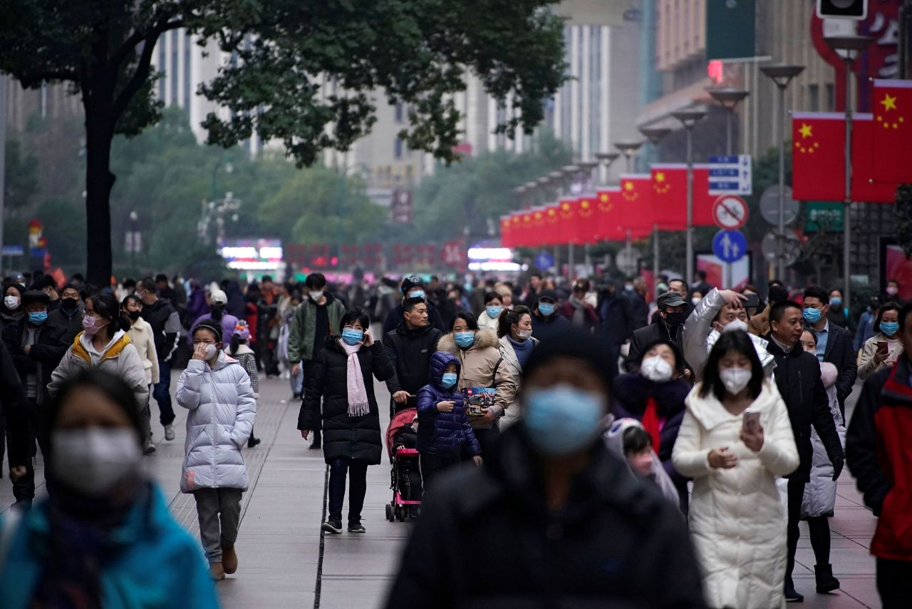 People wear masks at the Nanjing Pedestrian Road, a main shopping area, in Shanghai on Friday.