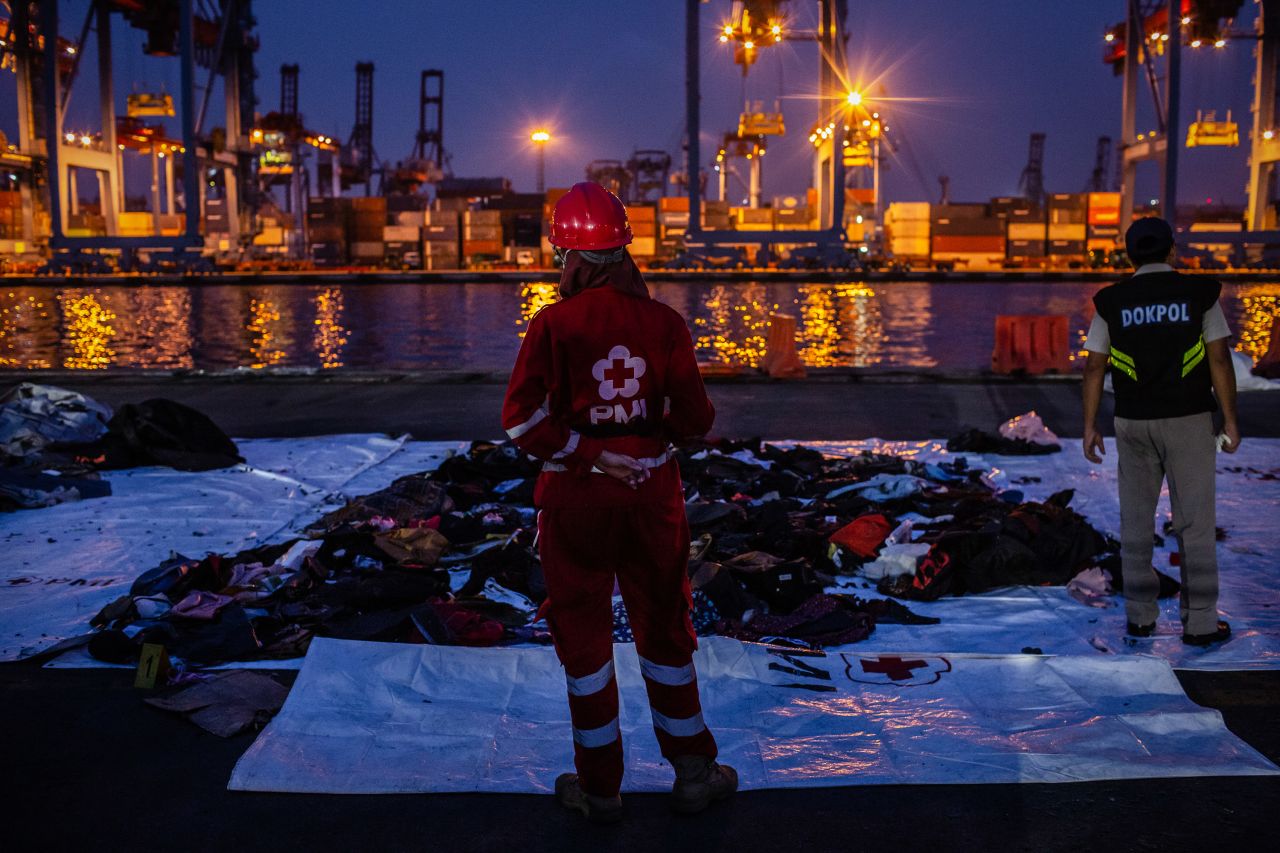 An Indonesian red cross member stands in front of recovered personal items from Lion Air flight JT 610 at the Tanjung Priok port on?Tuesday in Jakarta.