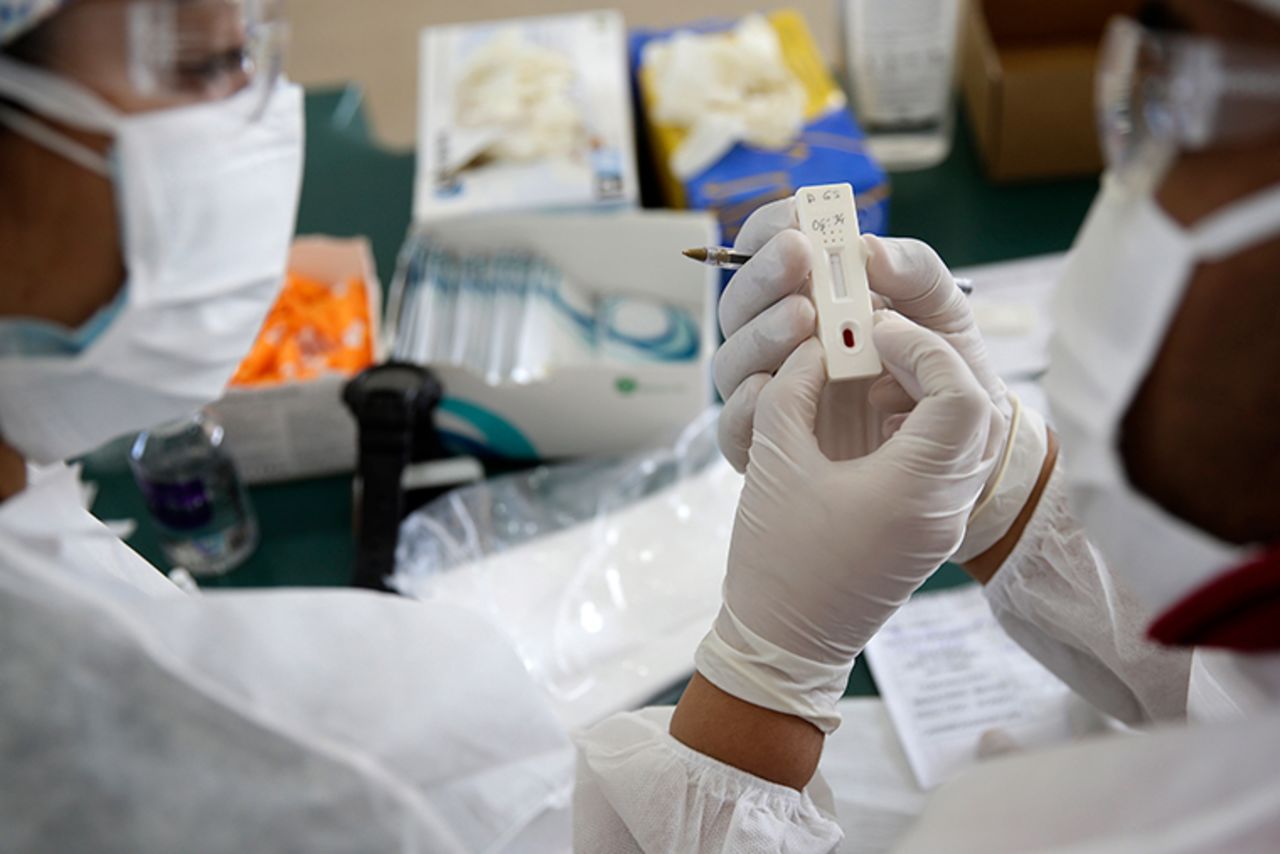 Health workers give COVID-19 tests to workers at the Central Supply of Agricultural products, the largest food market in Brasilia, Brazil, Monday, Aug. 24.