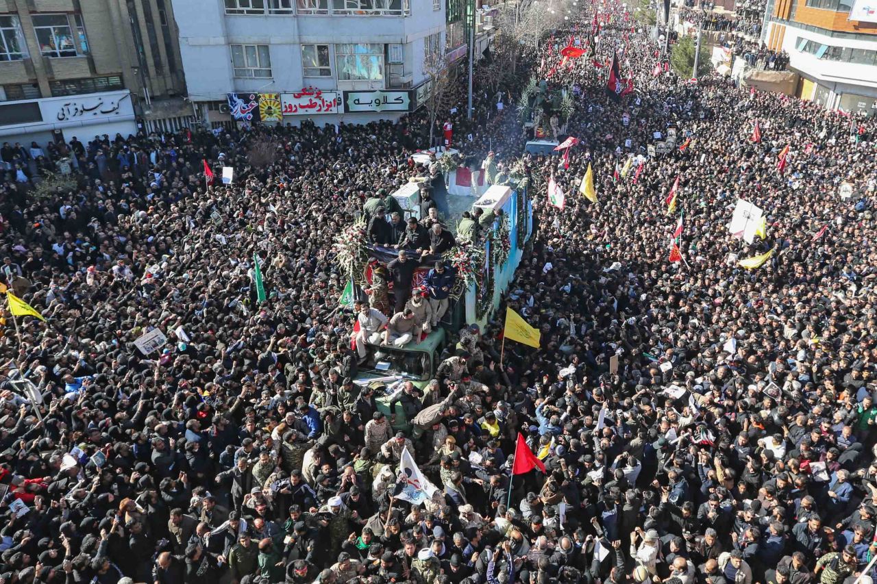 Iranian mourners gather around a vehicle carrying the coffin of Qasem Soleimani during his funeral procession in Kerman, Iran on Tuesday. Credit: Atta Kenare/AFP via Getty Images