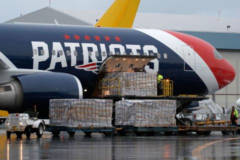 Palettes of N95 respirator masks are off-loaded from the New England Patriots football team's Boeing 767 jet on the tarmac at Logan Airport on April 2 in Boston.