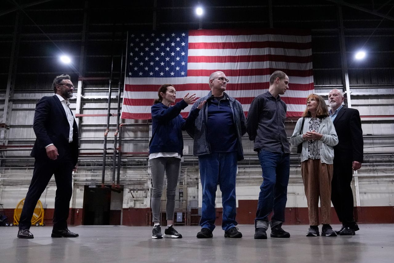 Alsu Kurmasheva, second from left, stands with Paul Whelan, center, and Evan Gershkovich, third from right, at Kelly Field in San Antonio, Texas, on Friday, August 2.