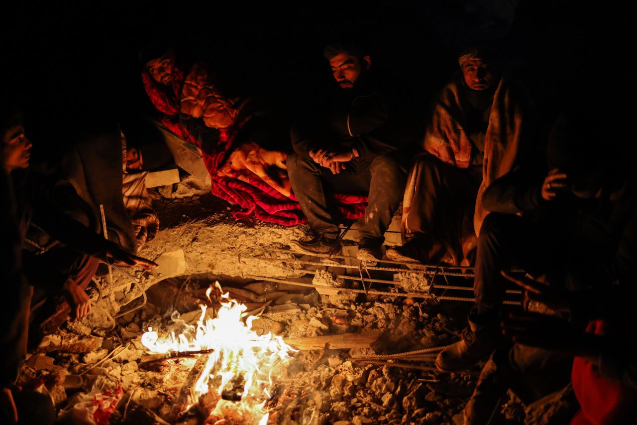 Earthquake survivors wait for their relatives to be saved in the city of Jandairis, Syria, on Wednesday.