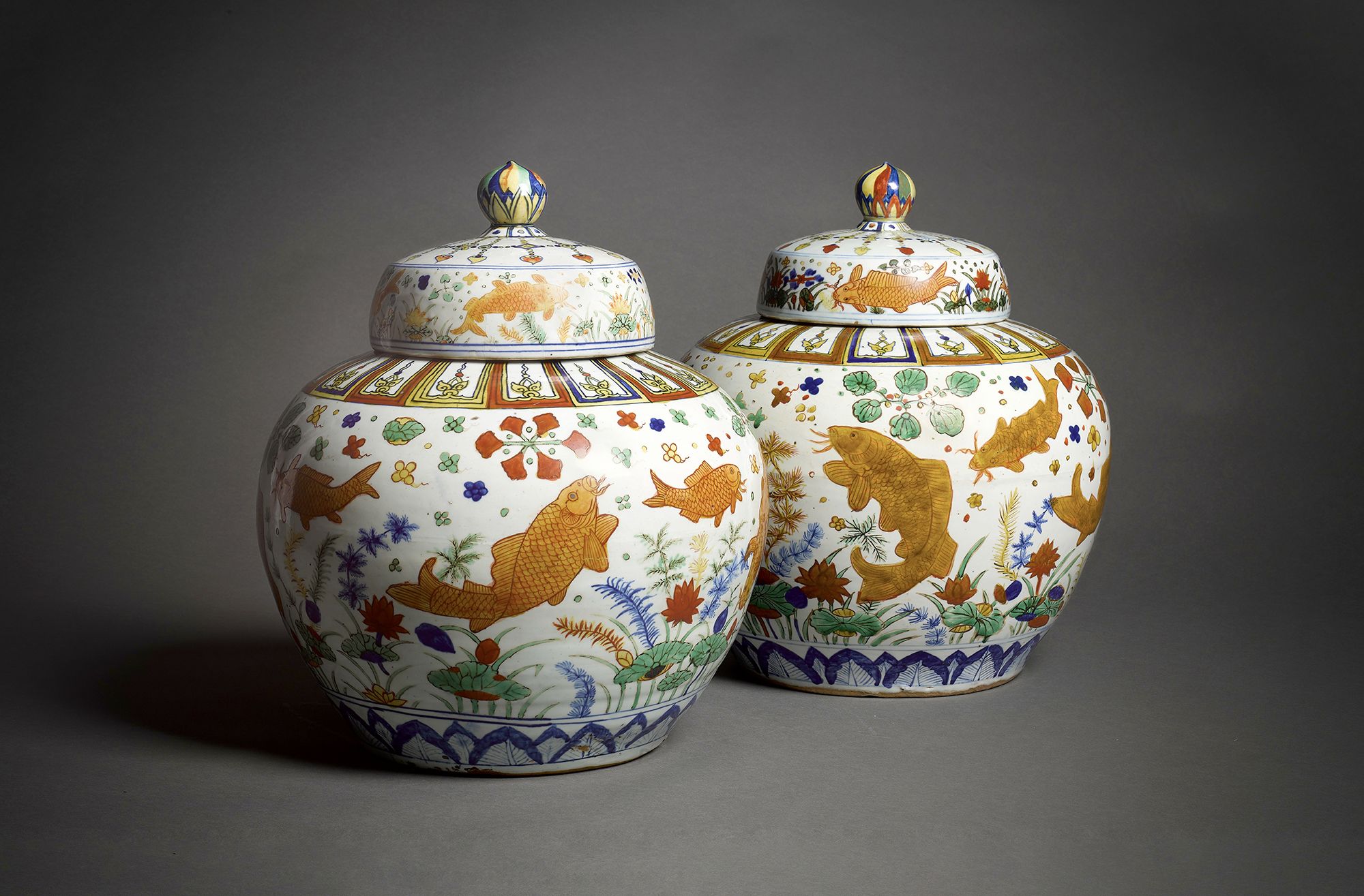 A magnificent and exceptionally rare pair of fish jars and covers.