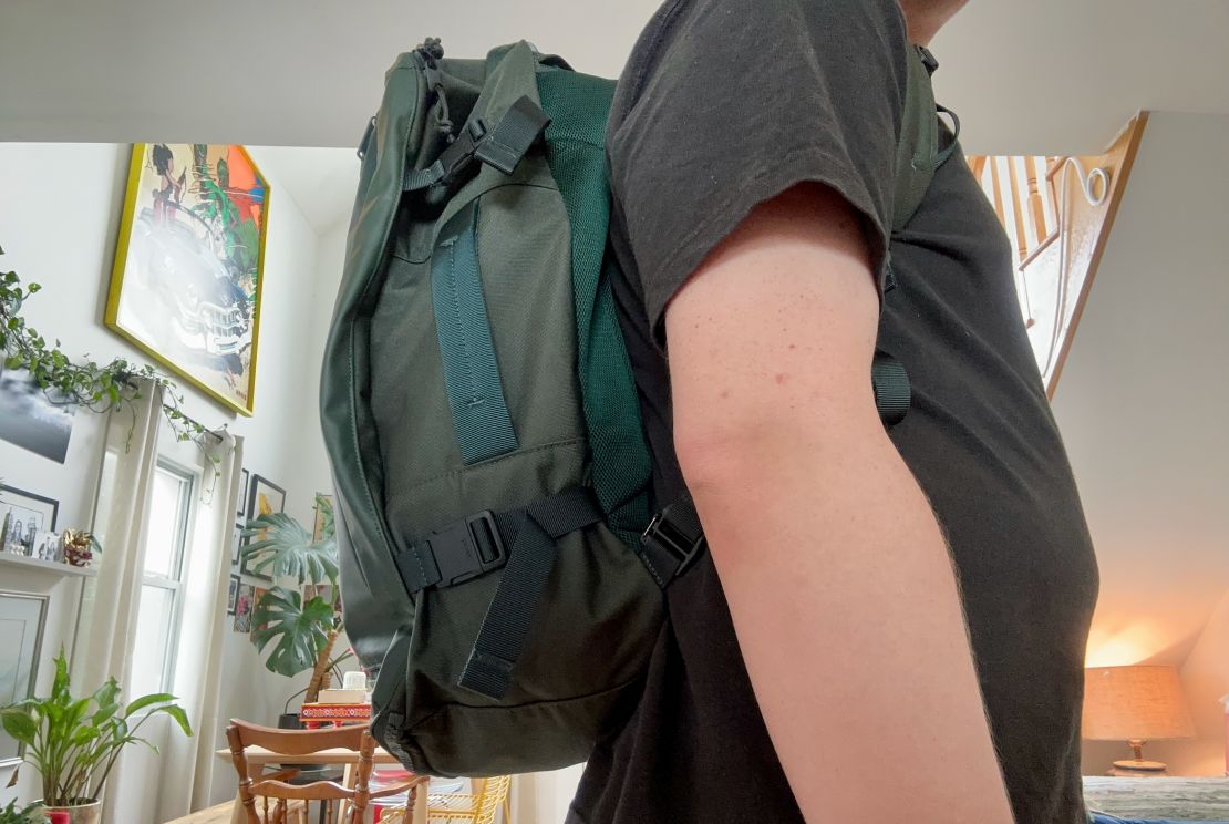 A person wearing the Away FAR 45L convertible backpack