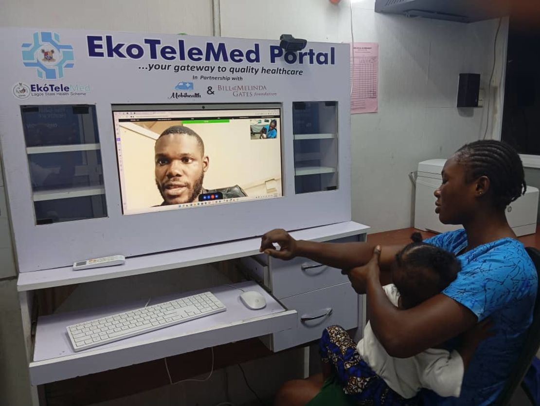 A young mother and child using a Mobihealth telemedicine service in rural area in Nigeria.