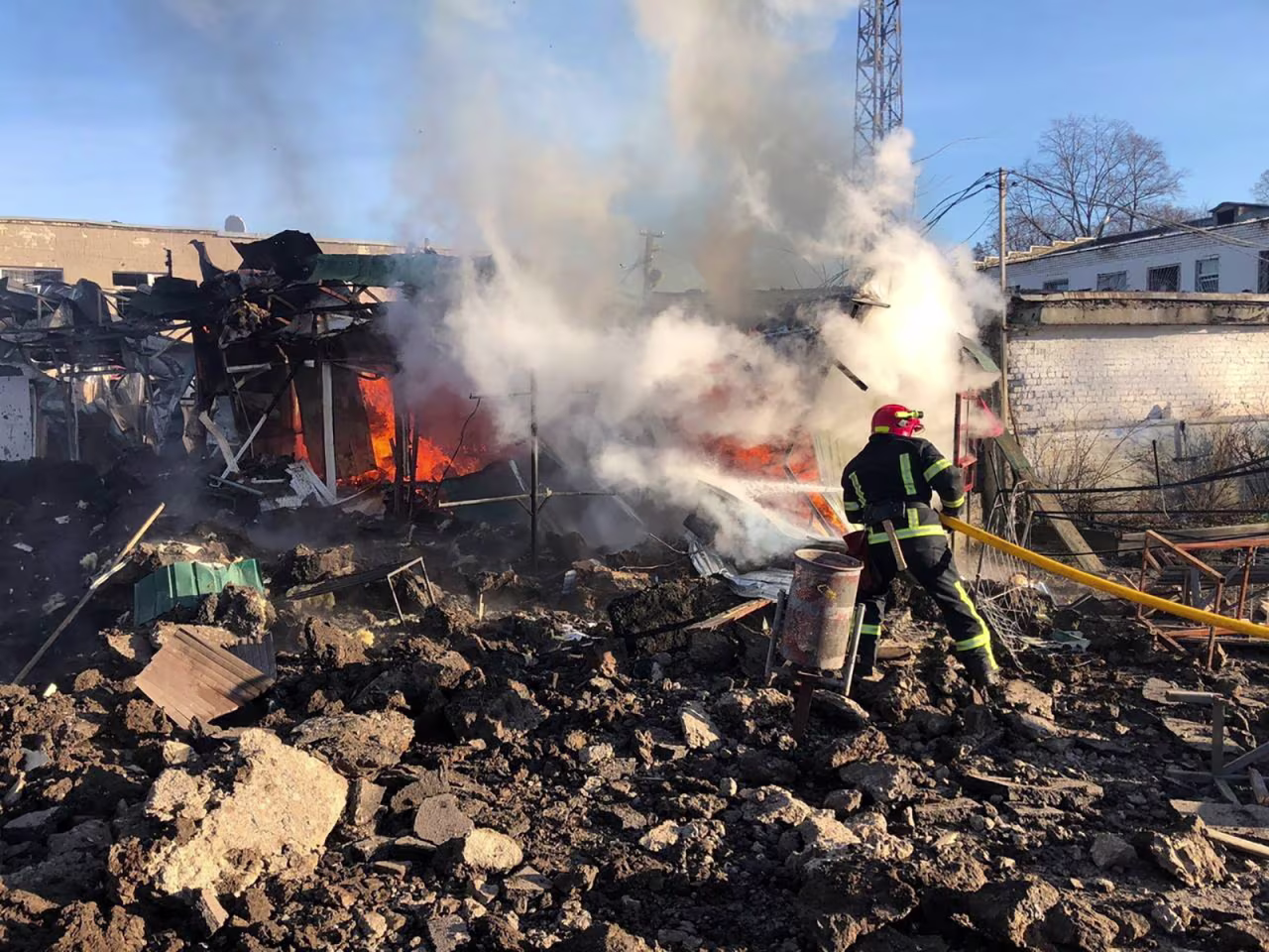 A firefighter works at a site of a market hit by Russian missiles in the town of Shevchenkove, Kharkiv region, Ukraine, on January 9.