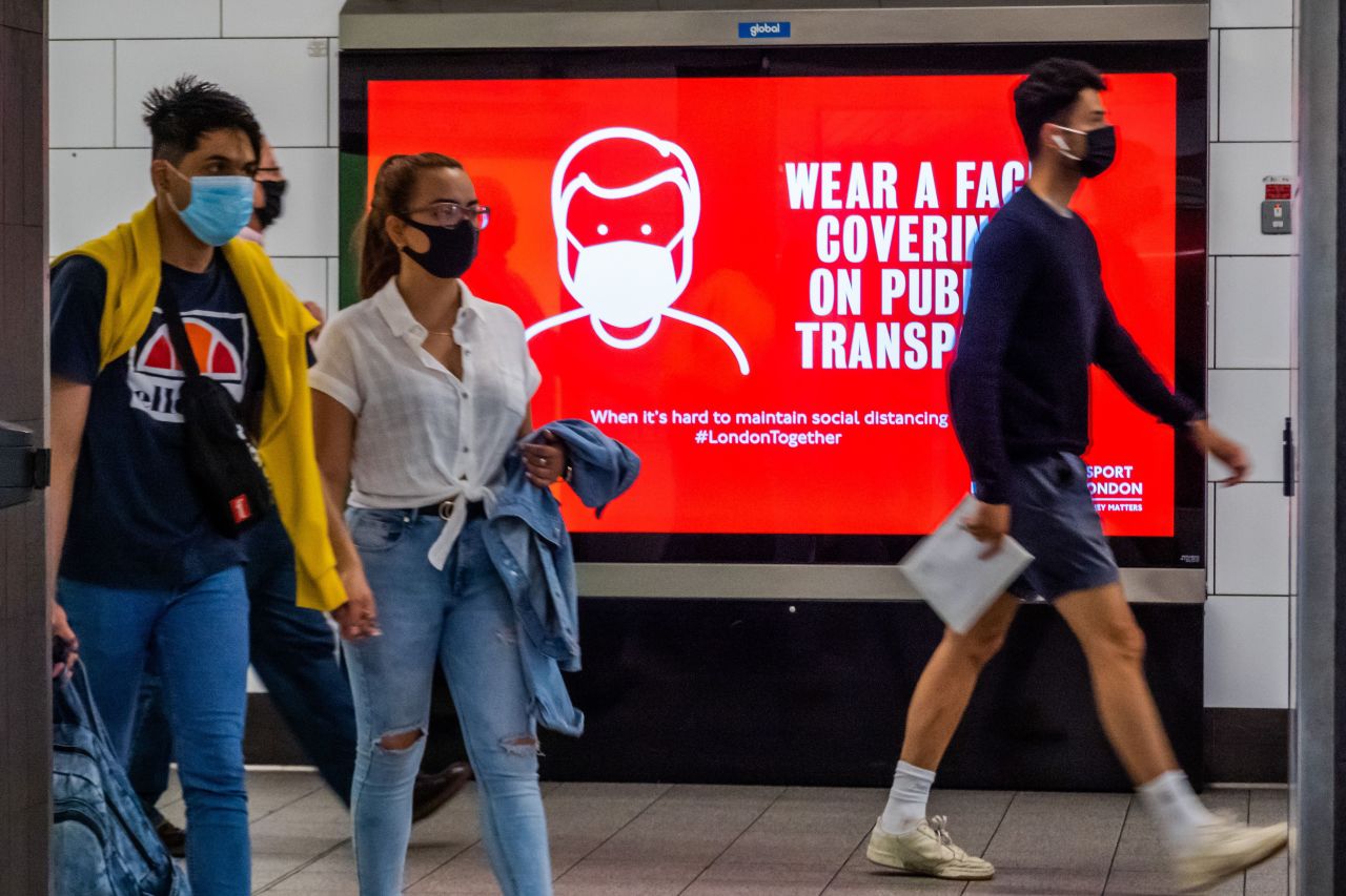 People walk at a train station in London on July 23.