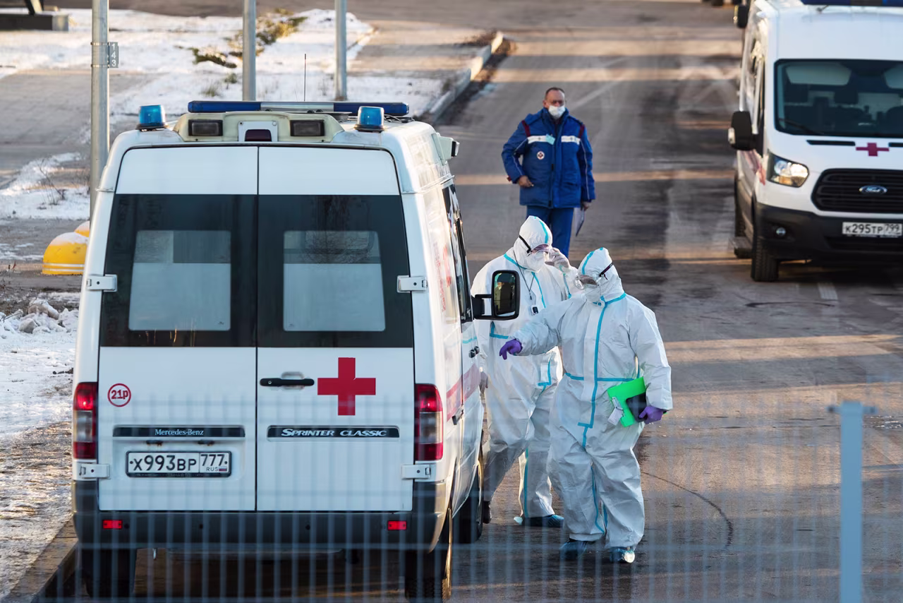 Medical workers wearing protective gear return to their ambulance after transferring a patient suspected of having Covid-19 at a hospital in Kommunarka, outside Moscow, on December 5.