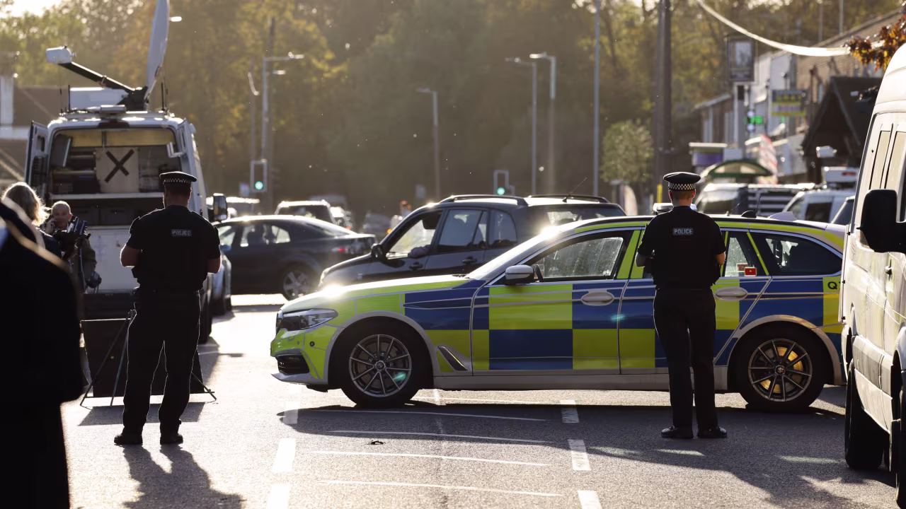 Police officers work near the scene of the crime on Friday.