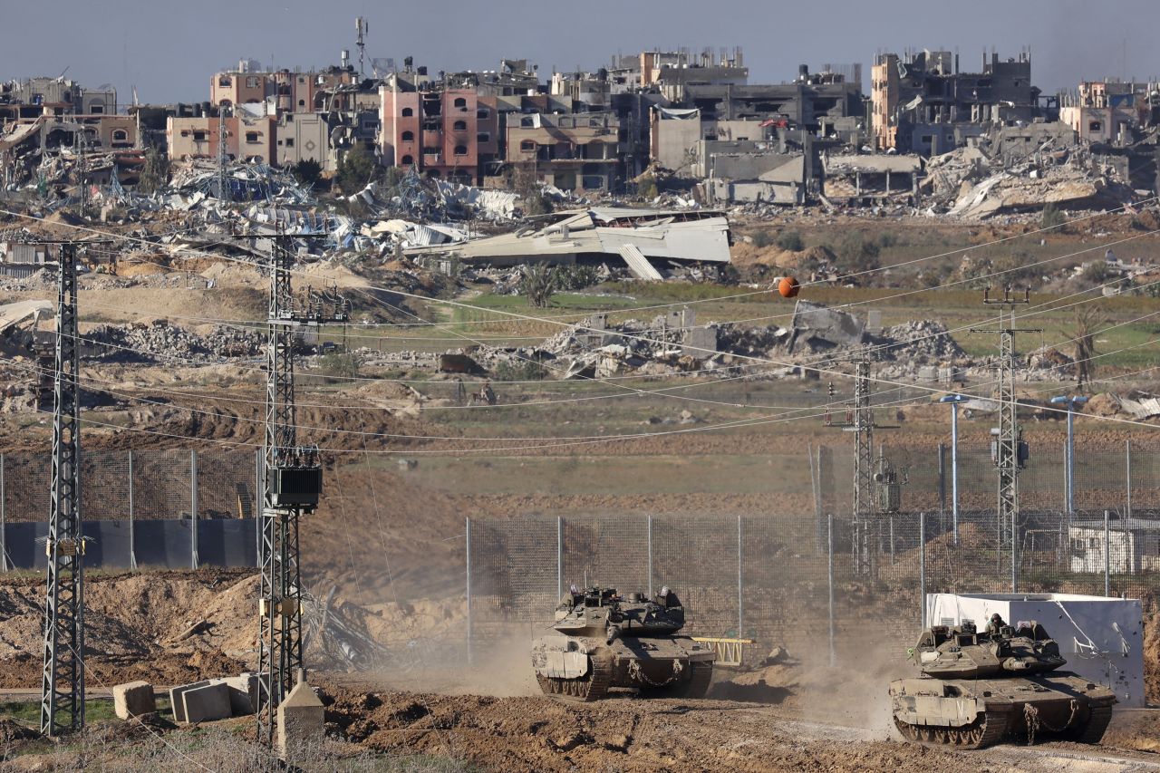 A picture taken from southern Israel, on the border with Gaza, shows Israeli tanks returning from northern Gaza on December 16.