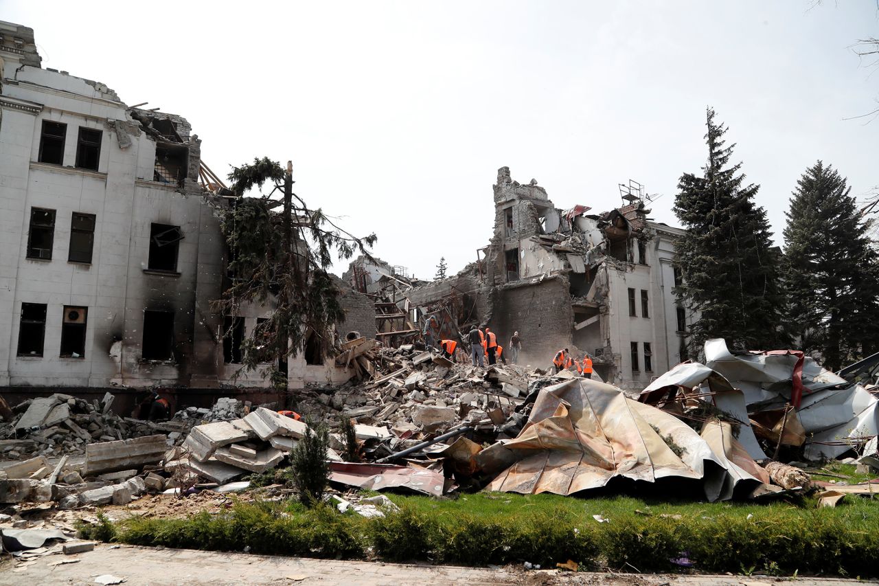 Emergency workers and volunteers remove debris in April after Russian strikes on the Mariupol Drama Theater.