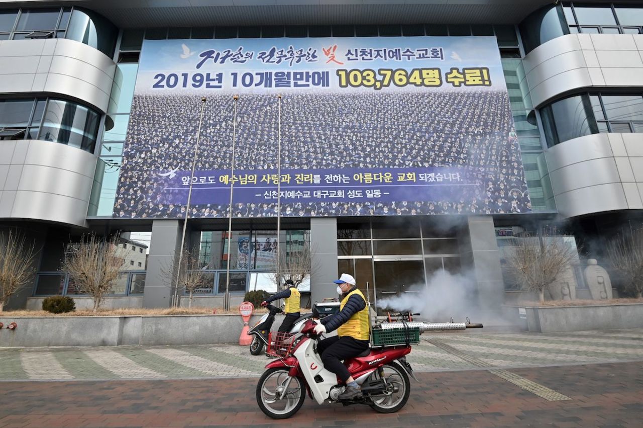 South Korean health officials spray disinfectant in front of the Shincheonji Church of Jesus in the southeastern city of Daegu on February 21, 2020.