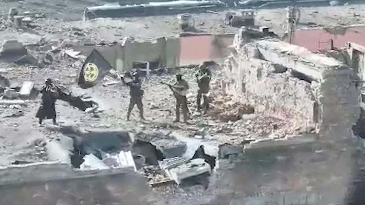 A still image taken from video released on March 2 by founder of Russia's Wagner Group Yevgeny Prigozhin's press service, shows what it said to be Wagner fighters standing with a flag on top of a building in Bakhmut, Ukraine.