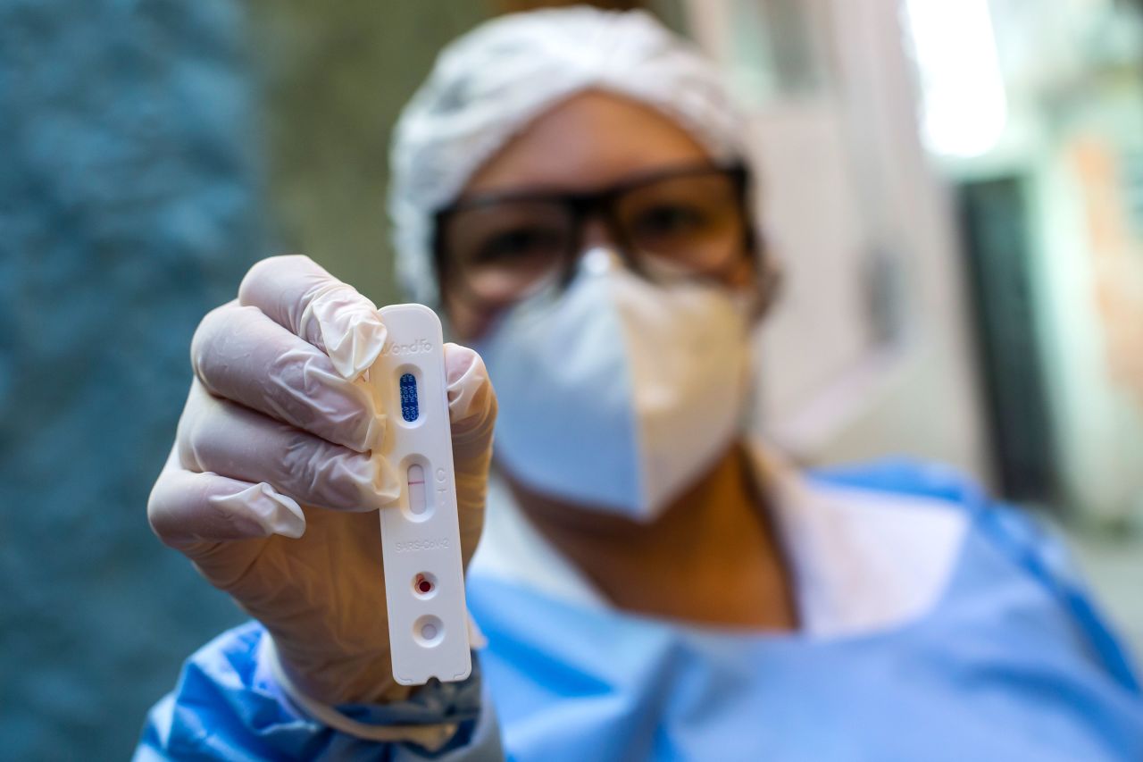 A city health agent holds a positive Covid-19 rapid test on September 3 in Rio de Janeiro, Brazil. 