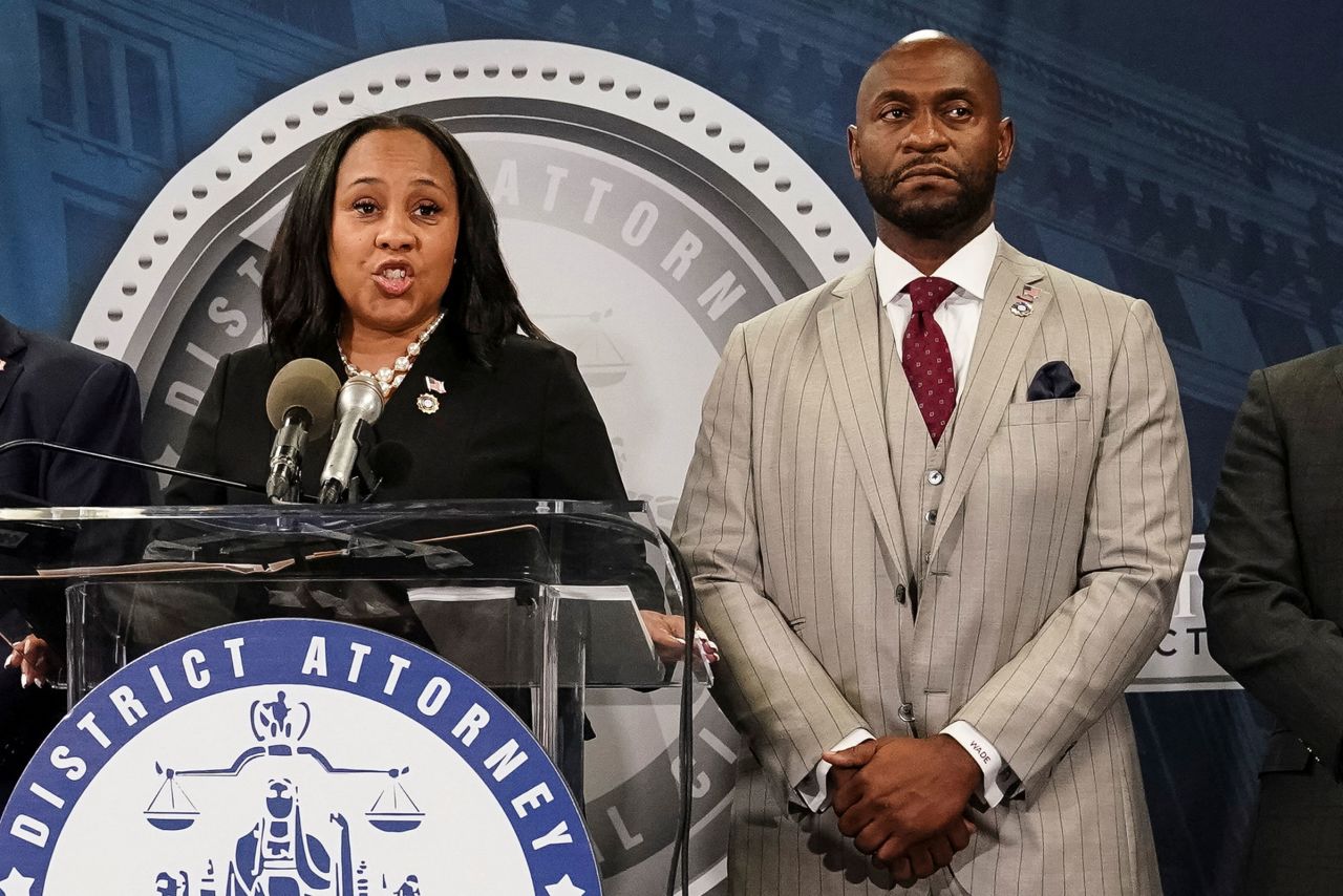 Fulton County District Attorney Fani Willis speaks at a press conference next to prosecutor Nathan Wade after a Grand Jury brought back indictments against former president Donald Trump and his allies in their attempt to overturn the state's 2020 election results, in Atlanta.